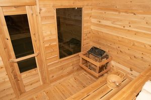 Inside the Dundalk Leisurecraft Canadian Timber Luna Sauna viewing the 6KW heater, front door, front window, water bucket and ladle