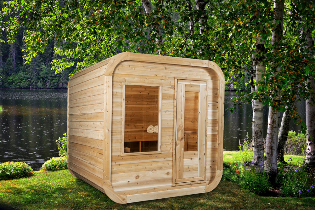 Dundalk Leisurecraft Canadian Timber Luna Sauna sitting outside facing right in a gorgeous backyard with a pond in the back