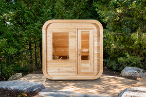Dundalk Leisurecraft Canadian Timber Luna Sauna sitting outside facing front in a gorgeous backyard