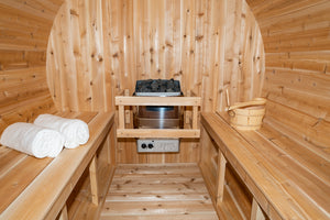 Inside the Dundalk Leisurecraft Canadian Timber Harmony Barrel Sauna viewing 6KW heater, towels, water bucket and ladle
