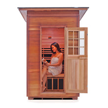 Load image into Gallery viewer, Enlighten Sauna Sierra 2 Person Slope Roof facing front with woman inside reading a magazine with the door open